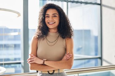 Branding headshot of Austin professional woman in office setting with natural window light