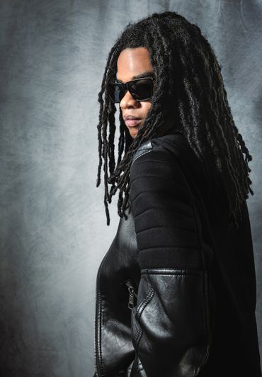 Lifestyle branding portrait of a creative professional wearing a black leather jacket and sunglasses