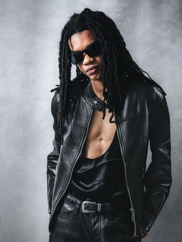 Studio portrait of a male model in a leather jacket, sunglasses, fashion professional branding photo