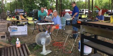 Amateur radio operators talking on radio for field day