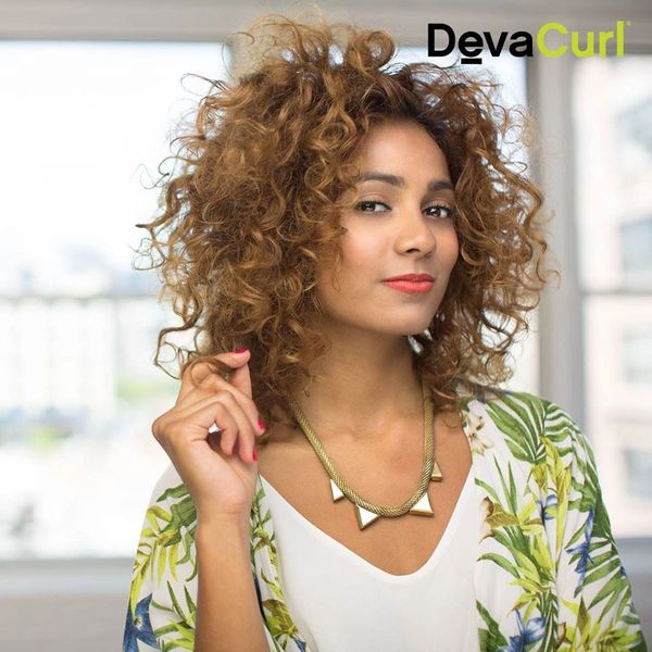 Curly hair model holding touching her hair