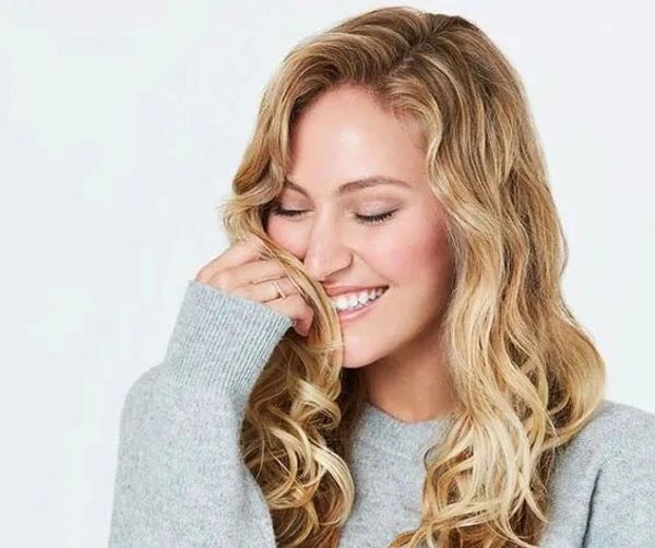 Deva Curl wavy hair model smiling