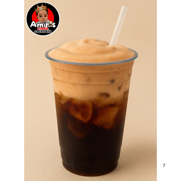 Iced coffee with a thick, creamy foam top in a clear plastic cup.
