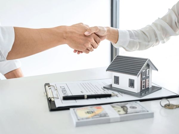 people shaking hands over a house project and contract