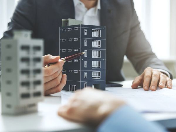 real estate developer and architect discussing new housing development project in office