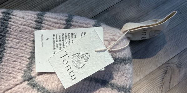 Close-up of a knitted fabric with Tonttu labels.