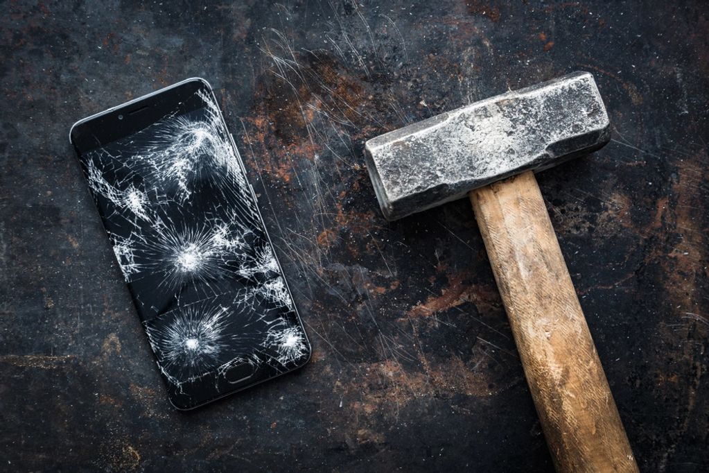 smashed cellphone and hammer