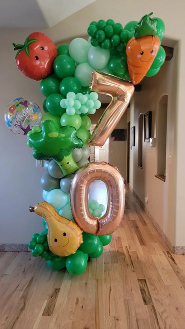 Garden themed balloons for a 70th birthday party. Tomato, Carrot, Broccoli, and Squash balloons.