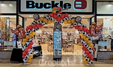 Cowboy balloon arch with boots and guitar for mall event.