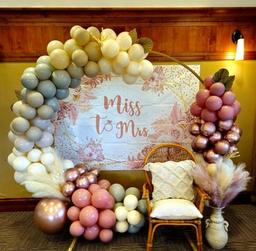 Balloon Hoop with feather decor and a chair for a bachelorette party.