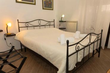 Cozy bedroom with a wrought iron bed and neatly arranged towels.