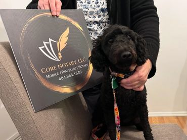 happy dog puppy holding sign for core notary llc