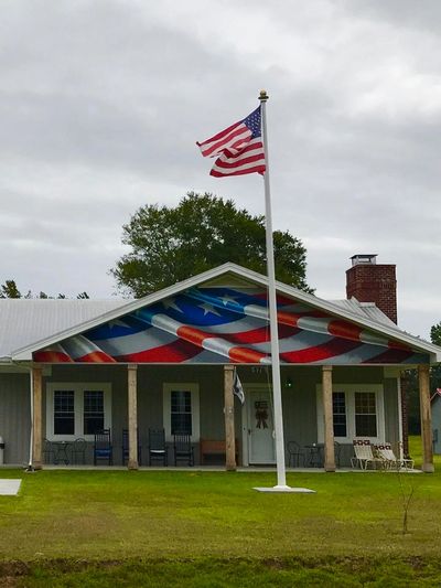 Flag flying in front of Camp4Heroes lakeview camp and retreat center