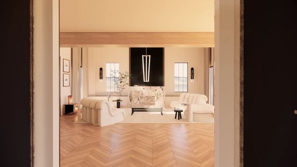 View from the entrance of an open space living room with chevron parquet and modern furniture.
