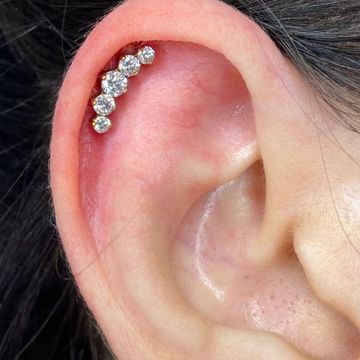 Ear with a diamond cartilage piercing.