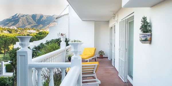 Balcony overlooking scenic hills and lush trees