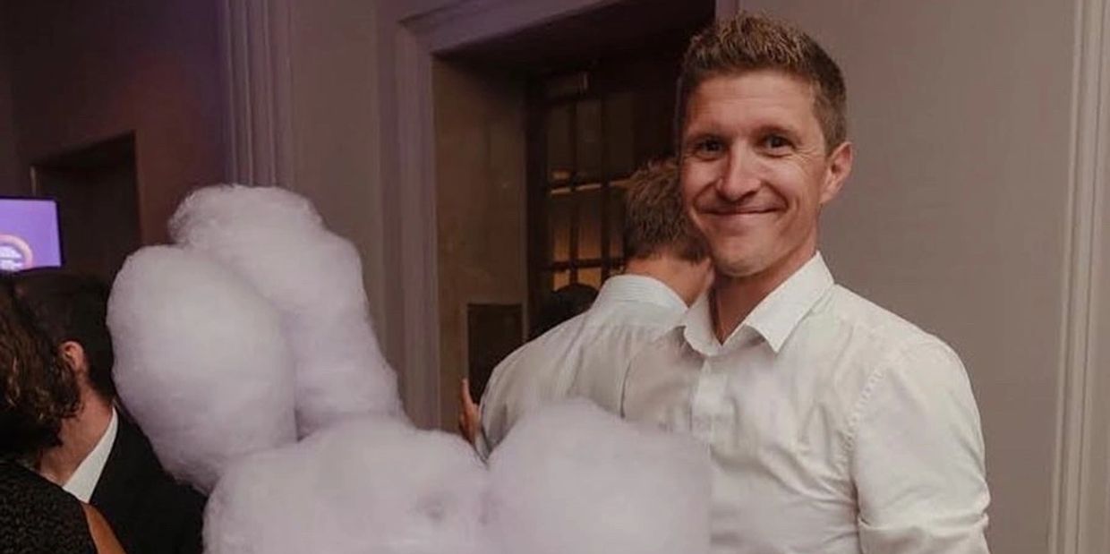 Photo of Timothy Stachecki holding cotton Candy Barbe à papa in his hands at an event in Montreal.