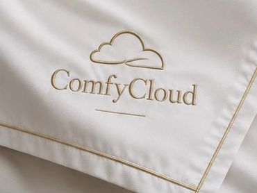 Elegant white fabric with gold embroidered ComfyCloud logo and piping.