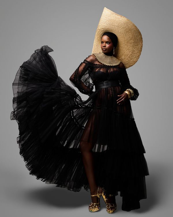 Stylish evening look with a model in gown and gold accessories