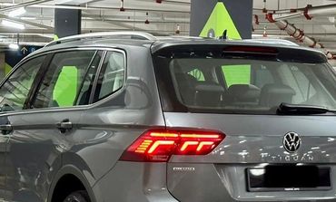 Gray Volkswagen Tiguan parked in an indoor parking garage.
