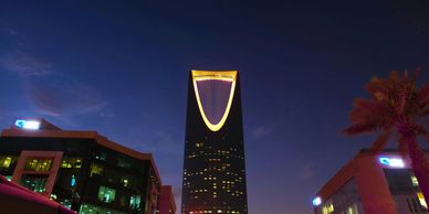 Kingdom Centre Tower in lit up at night with the night sky in the background