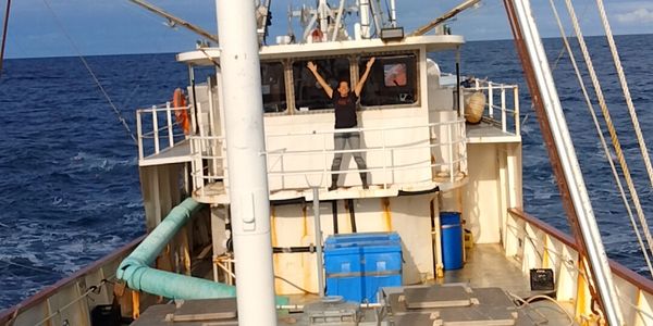 Steel tuna freezer troller at sea. RSW chiller box in front of house. Tuna boat for sale in BC