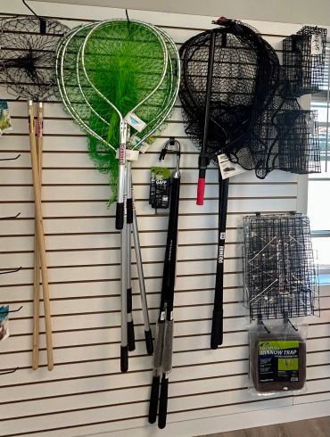 Fishing nets and trap cages displayed on wall.