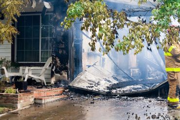 Side of a home damaged by fire.