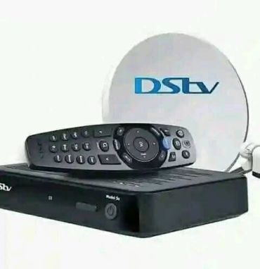 DSTV satellite dish, decoder, and remote control.