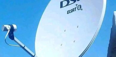 DSI satellite dish under clear sky.