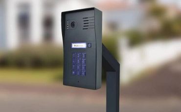 Black keypad security intercom system on a stand.
