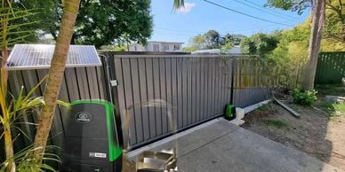 Automatic sliding gate with security system and solar panel.