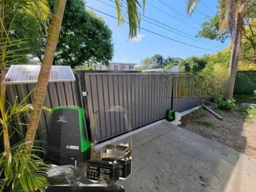 Automatic sliding gate with security system and solar panel.