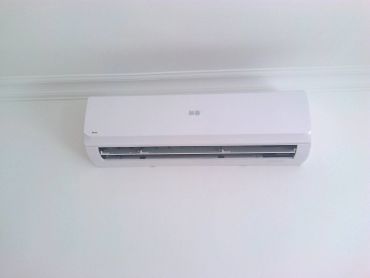 A white Jet-Air air conditioner mounted on a wall.