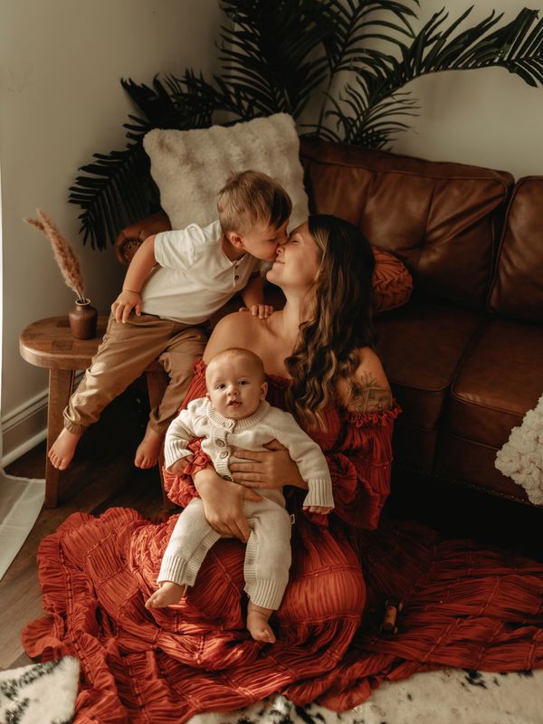 Motherhood session in South Carolina featuring a mother holding her baby while cuddling her toddler