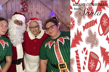 Santa, Mrs. Claus, and elves pose for a festive Christmas photo.