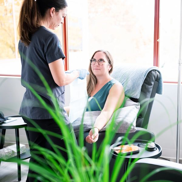 A woman receiving medical care in a bright clinic room.