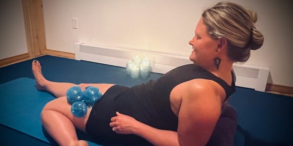 woman using cupping therapy with yin yoga for myofascial release (MFR) in a private yoga session.