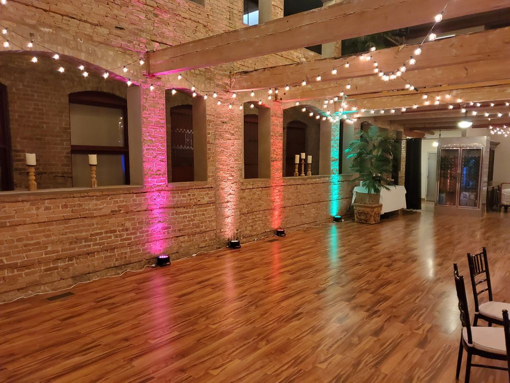 Ask about our uplighting. Uplighting for wedding on a brick wall with variety of colors