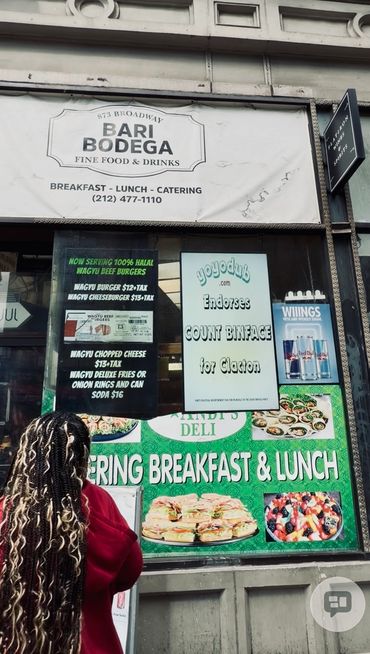 Signage outside Bari Bodega with menu and endorsements.