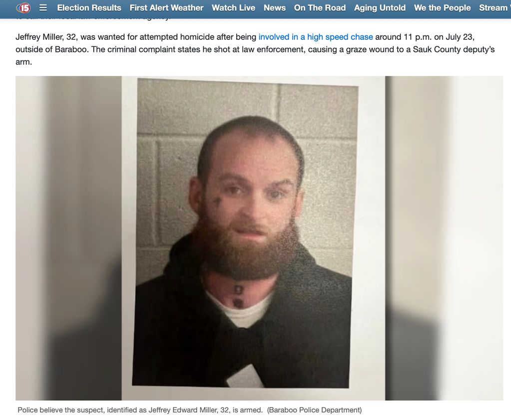 Mugshot of a bearded man with a tattoo on his neck.