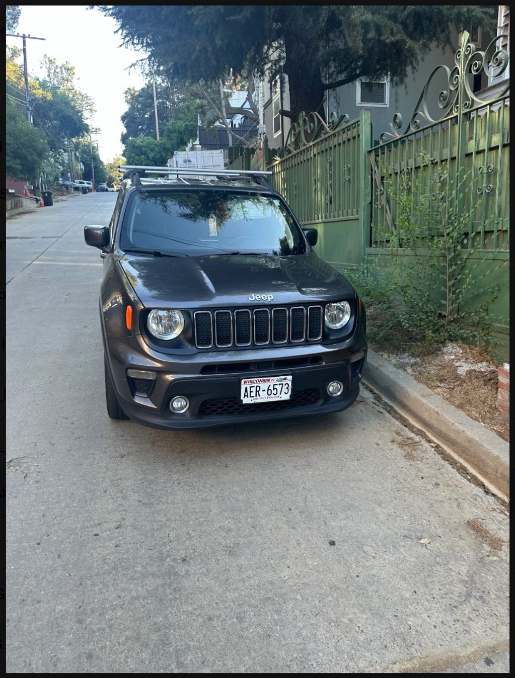 Black Jeep SUV parked on street.