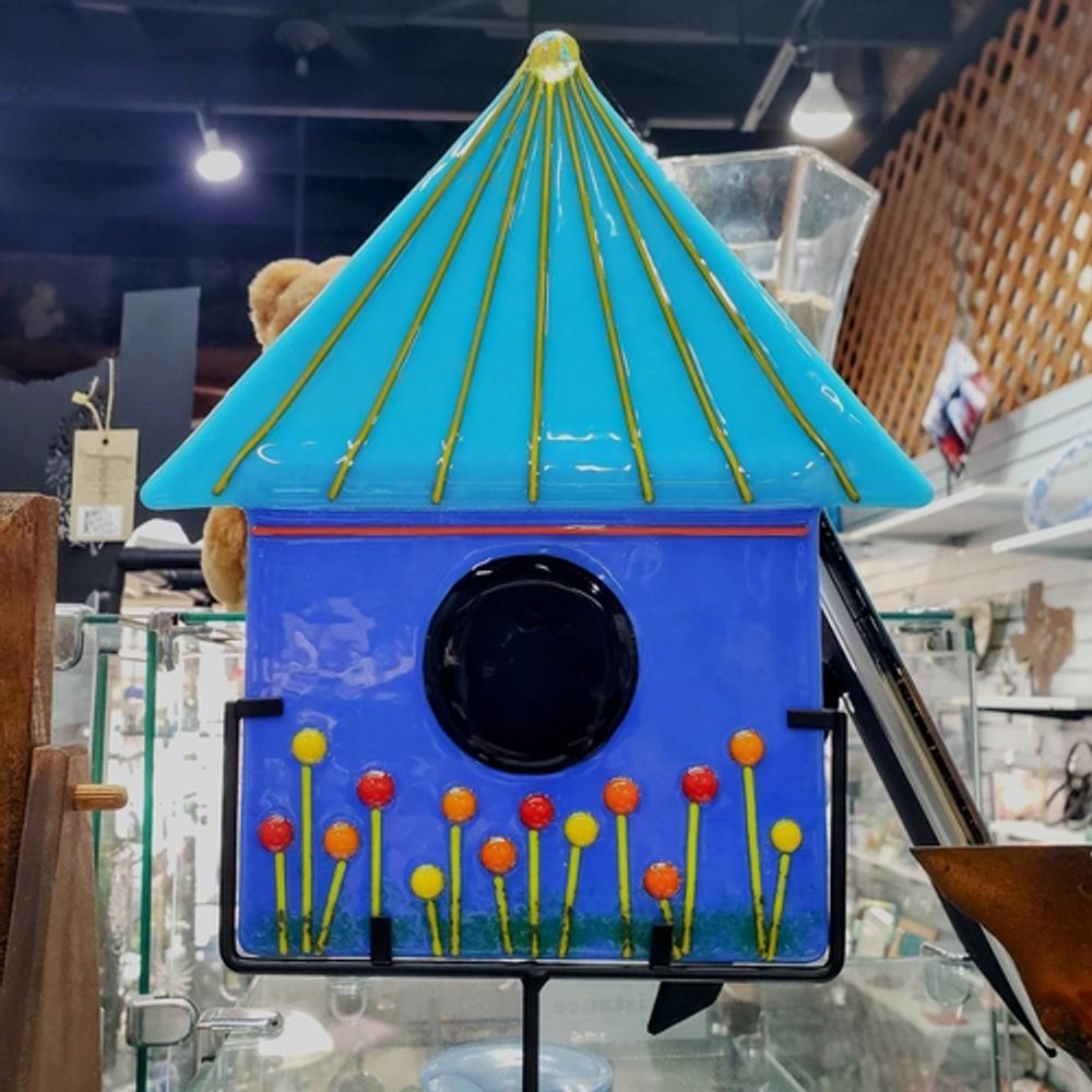 A beautiful fused glass blue birdhouse with a metal stand is waiting for your happy garden!