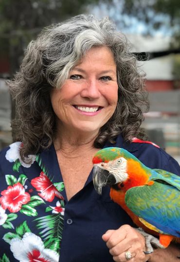 Promo head shot with Nancy and Squeak the Catalina Macaw