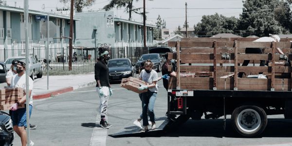 Charity organization volunteers unload food to be distributed to people in need.