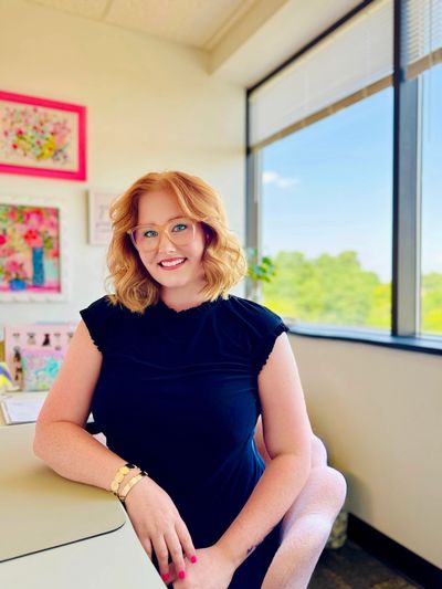 A woman sitting on the chair and looking ahead