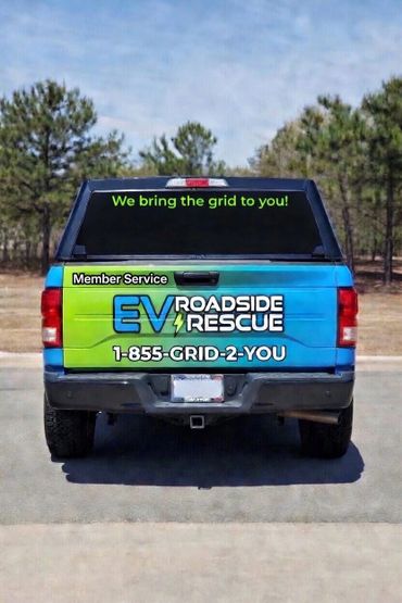 Back of a truck advertising EV Roadside Rescue service with a contact number.