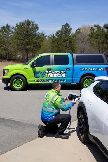 Technician charging an electric vehicle roadside with EV Roadside Rescue truck.
