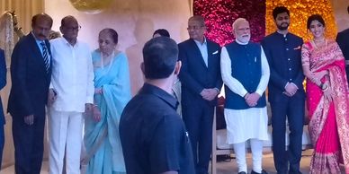 Group photo at an event with decorative floral backdrop.