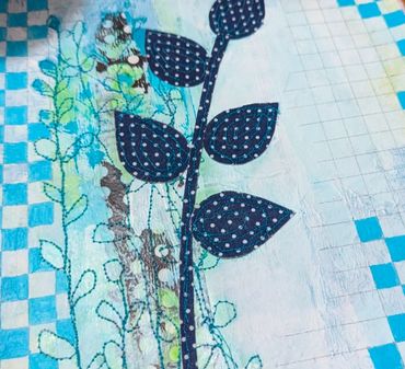 Blue leaf pattern on a textured, mixed-media background with grid and checkered designs.